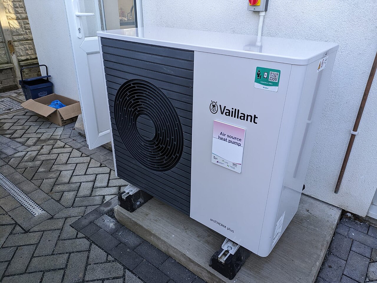 Unità esterna di una pompa di calore accanto a una facciata